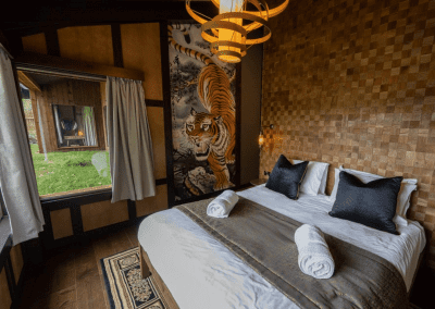 Interior of West Midlands Safari Park Lodges, a selection of safari inspired lodges with vibrant bedrooms, featuring bespoke curtains and soft furnishings with elegant styling.