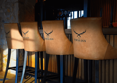 Interior of a grade II listed Inn featuring bespoke pub furniture including dining chairs, bar stools, and tables to enhance the heritage charm of the Inn.
