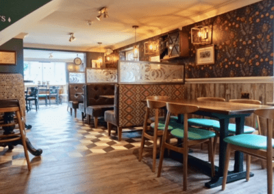 Bespoke pub furniture at Shipmans Northampton, including fixed seating, wooden dining tables, and classic chairs designed to enhance the pub’s historic charm.