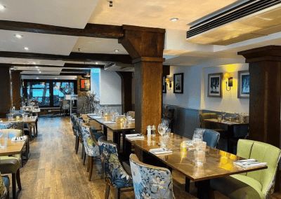 Interior of the dining and lounge areas for a countryside hotel, featuring furniture that complements its rich heritage and charming, traditional style.