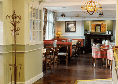 Interior of a family country inn featuring traditional fixed seating, dining and bar furniture, and refurbished pub furniture to enhance the heritage appeal of the pub.
