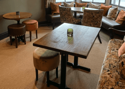 Interior of Ye Horns Inn, a grade II listed Inn featuring bespoke pub furniture including dining chairs, bar stools, and tables to enhance the heritage charm of the Inn.