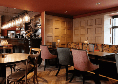 Interior of a country-style pub featuring contract furniture and soft furnishings, blending heritage charm with contemporary comfort.