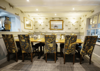 Interior of a family country inn featuring traditional fixed seating, dining and bar furniture, and refurbished pub furniture to enhance the heritage appeal of the pub.