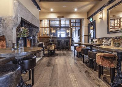Interior of a grade II listed Inn featuring bespoke pub furniture including dining chairs, bar stools, and tables to enhance the heritage charm of the Inn.