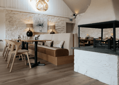 Interior of a country-style pub featuring contract furniture and soft furnishings, blending heritage charm with contemporary comfort.