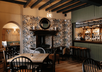 Interior of a country-style pub featuring contract furniture and soft furnishings, blending heritage charm with contemporary comfort.
