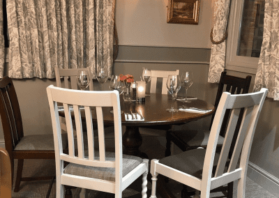 Interior of a family country inn featuring traditional fixed seating, dining and bar furniture, and refurbished pub furniture to enhance the heritage appeal of the pub.