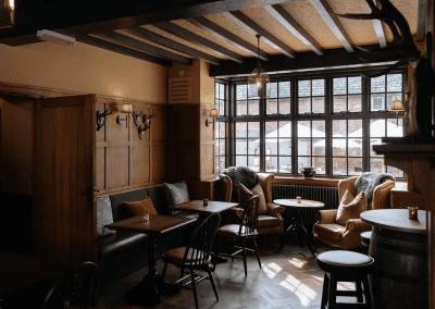 Interior of a country-style pub featuring contract furniture and soft furnishings, blending heritage charm with contemporary comfort.