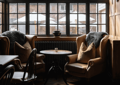Interior of a country-style pub featuring contract furniture and soft furnishings, blending heritage charm with contemporary comfort.