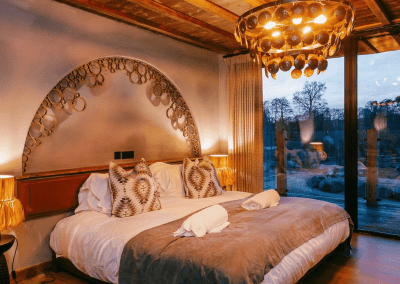 Interior of West Midlands Safari Park Lodges, a selection of safari inspired lodges with vibrant bedrooms, featuring bespoke curtains and soft furnishings with elegant styling.