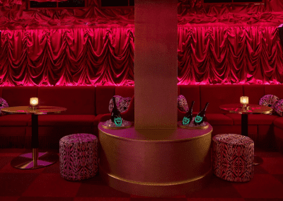 Interior of a stylish and immersive nightclub featuring bespoke soft furnishings and bespoke seating and furniture to enhance the nighttime atmosphere.