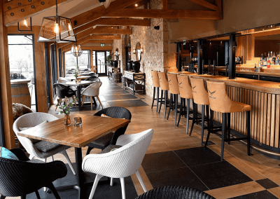 Interior of a grade II listed Inn featuring bespoke pub furniture including dining chairs, bar stools, and tables to enhance the heritage charm of the Inn.