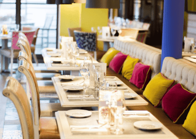 Interior of a traditional country pub featuring bespoke pub furniture including dining chairs, bar stools, and tables to enhance the vibrant yet traditional charm of the pub.