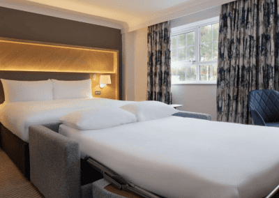 Hotel interior of Hilton Hotels, featuring contract hotel furniture and bespoke headboards to create an inviting and relaxed guest experience.