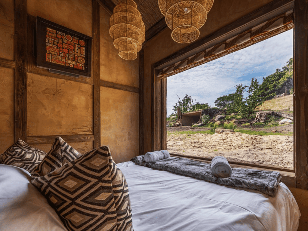 Interior of West Midlands Safari Park Lodges, a selection of safari inspired lodges with vibrant bedrooms, featuring bespoke curtains and soft furnishings with elegant styling.