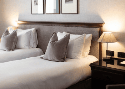 Hotel interior of DoubleTree Hilton Cheltenham, featuring contract hotel furniture and bespoke headboards to create an inviting and relaxed guest experience.