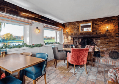 Interior of the dining and lounge areas for a countryside hotel, featuring furniture that complements its rich heritage and charming, traditional style.