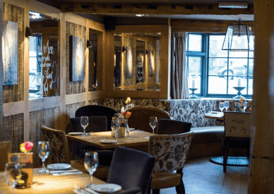 Interior of The Moat House featuring bespoke pub furniture including dining chairs, bar stools, and tables to enhance the vibrant yet traditional charm of the pub.