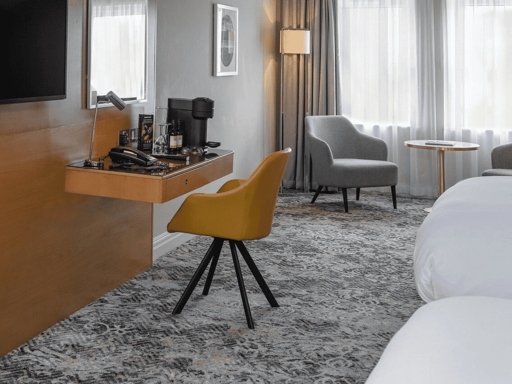 Interior of hotel rooms at Chesford Grange Hotel, featuring comfortable desk chairs, chaise longues, and tub chairs for a stylish, fresh look for this countryside retreat.