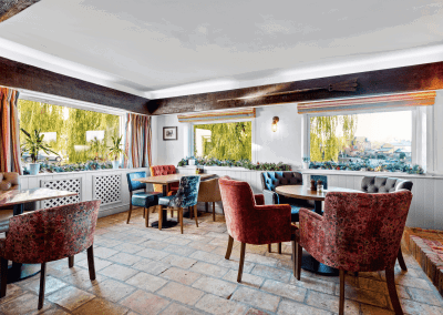 Interior of the dining and lounge areas for a countryside hotel, featuring furniture that complements its rich heritage and charming, traditional style.