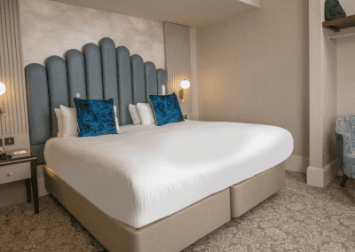Bedroom interiors for Clifton Hotel, a Victorian, seaside hotel featuring bespoke statement headboards, bedroom furniture and soft furnishings to complement the hotel’s aesthetic.