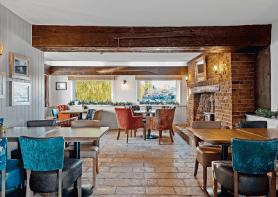 Interior of the dining and lounge areas for The Mill Sudbury, a countryside hotel, featuring furniture that complements its rich heritage and charming, traditional style.