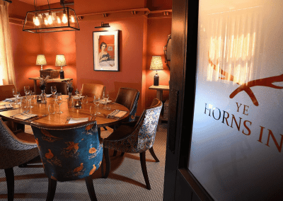 Interior of a grade II listed Inn featuring bespoke pub furniture including dining chairs, bar stools, and tables to enhance the heritage charm of the Inn.