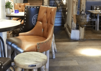 Interior of The Moat House featuring bespoke pub furniture including dining chairs, bar stools, and tables to enhance the vibrant yet traditional charm of the pub.