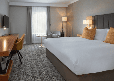 Interior of hotel rooms, featuring comfortable desk chairs, chaise longues, and tub chairs for a stylish, fresh look for this countryside retreat.