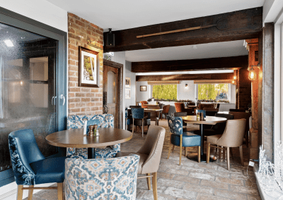 Interior of the dining and lounge areas for The Mill Sudbury, a countryside hotel, featuring furniture that complements its rich heritage and charming, traditional style.