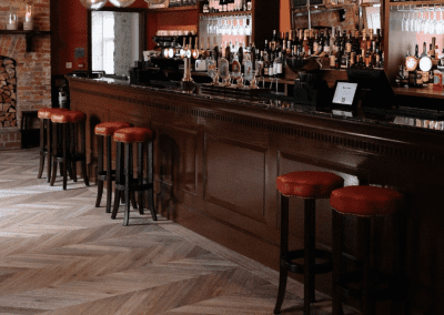 Interior of a country-style pub featuring contract furniture and soft furnishings, blending heritage charm with contemporary comfort.