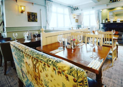 Interior of a family country inn featuring traditional fixed seating, dining and bar furniture, and refurbished pub furniture to enhance the heritage appeal of the pub.