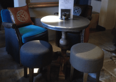 Interior of a traditional country pub featuring bespoke pub furniture including dining chairs, bar stools, and tables to enhance the vibrant yet traditional charm of the pub.