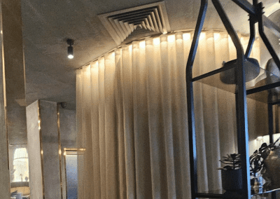 Bespoke wave voile curtains at a Michelin star restaurant, enhancing the modern and elegant interior with tailored soft furnishings.