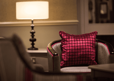 Interiors of a coastal hotel featuring contract furniture, lounge seating, bedroom furniture, and bespoke curtains, pelmets, and blinds reflecting the hotel’s vibrant coastal design.