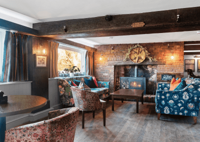 Interior of the dining and lounge areas for The Mill Sudbury, a countryside hotel, featuring furniture that complements its rich heritage and charming, traditional style.