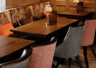 Interior of a country-style pub featuring contract furniture and soft furnishings, blending heritage charm with contemporary comfort.