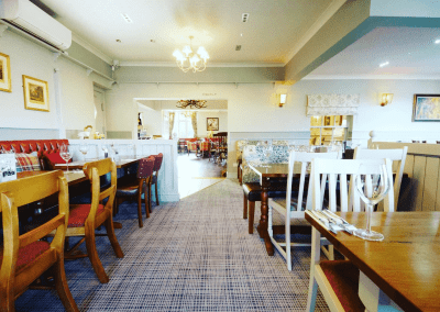 Interior of a family country inn featuring traditional fixed seating, dining and bar furniture, and refurbished pub furniture to enhance the heritage appeal of the pub.