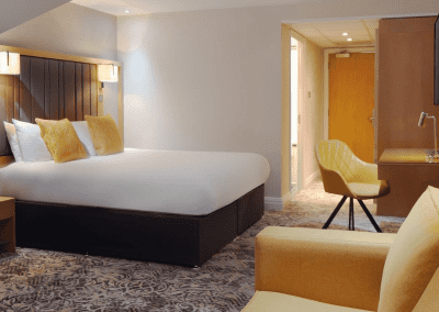 Interior of hotel rooms, featuring comfortable desk chairs, chaise longues, and tub chairs for a stylish, fresh look for this countryside retreat.