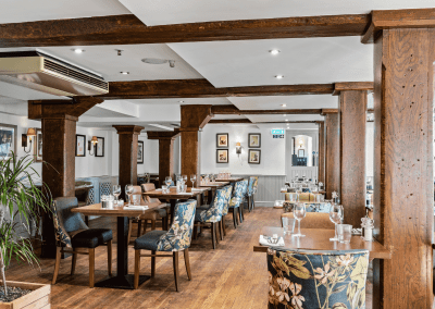 Interior of the dining and lounge areas for The Mill Sudbury, a countryside hotel, featuring furniture that complements its rich heritage and charming, traditional style.