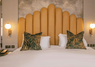 Bedroom interiors for a Victorian, seaside hotel featuring bespoke statement headboards, bedroom furniture and soft furnishings to complement the hotel’s aesthetic.
