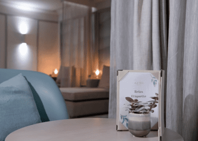 Interior of a hotel pool and spa area, featuring relaxing and comfortable lounge day beds, lounge chairs, and sofas for a calm and serene atmosphere.