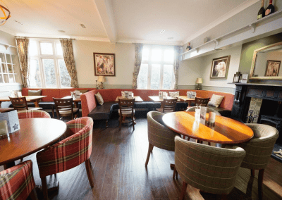 Interior of a family country inn featuring traditional fixed seating, dining and bar furniture, and refurbished pub furniture to enhance the heritage appeal of the pub.