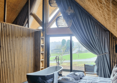 Interior of a selection of safari inspired lodges with vibrant bedrooms, featuring bespoke curtains and soft furnishings with elegant styling.