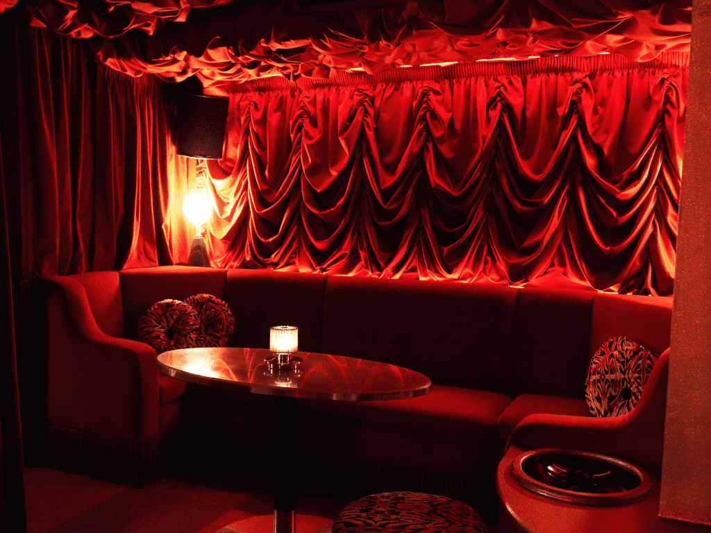 Interior of a stylish and immersive nightclub featuring bespoke soft furnishings and bespoke seating and furniture to enhance the nighttime atmosphere.