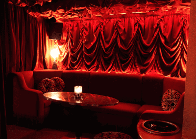 Interior of a stylish and immersive nightclub featuring bespoke soft furnishings and bespoke seating and furniture to enhance the nighttime atmosphere.