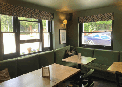 Pub Interior featuring bespoke bar stools, dining chairs, tables, curtains, and cushions to create a cricket-inspired atmosphere.
