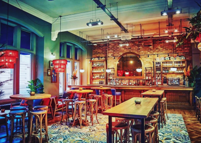 Bespoke restaurant seating in vibrant colours and bold fabrics for Sonrisa Leicester, an Argentinian-inspired restaurant with a lively atmosphere.