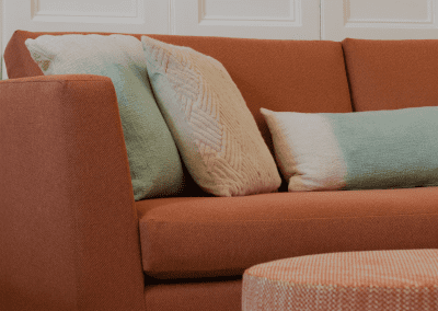 Refurbished common room, featuring durable compact sofas, tub chairs, and dining furniture in uplifting tones.